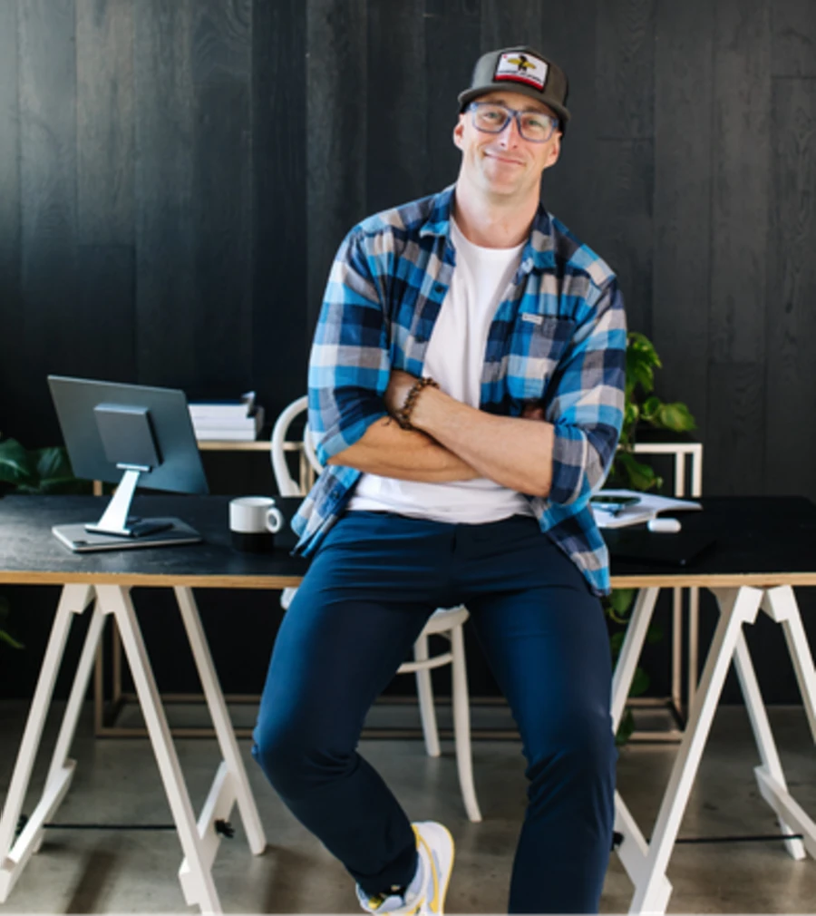 Steve at a desk with a laptop, sleeves up.